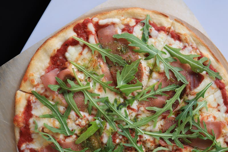 Prosciutto e Rucola punch pizza with cured ham and arugula